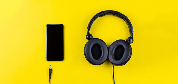 Close-up of vintage car on yellow background