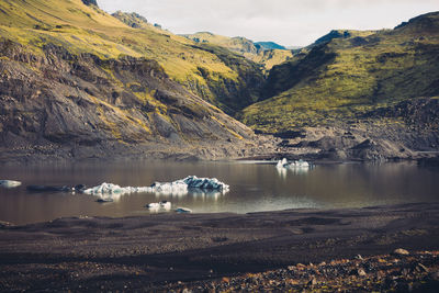 Scenic view of lake by mountains