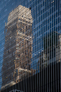 Low angle view of modern glass building in city