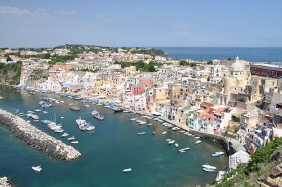 High angle view of townscape by sea against sky