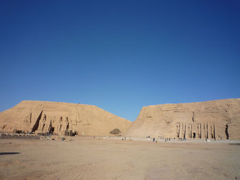 Scenic view of desert against clear blue sky