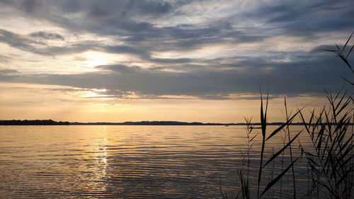 Scenic view of lake chiemsee against sky during sunset