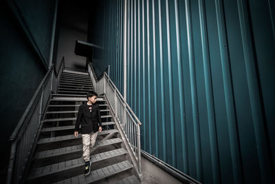 Boy moving down on steps in building