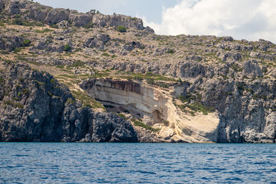 View from a motor boat on the mediterranean sea at the rocky coastline near stegna