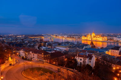 High angle view of city lit up at night