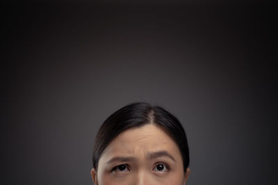 Portrait of young man against black background
