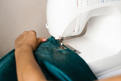 Close-up shot of female hands of a woman who sees on a sewing machine