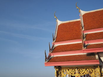 Low angle view of building roof against sky