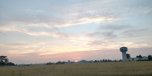 Scenic view of field against sky during sunset