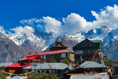 Houses and mountains against sky