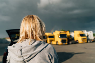 Rear view of woman standing against sky