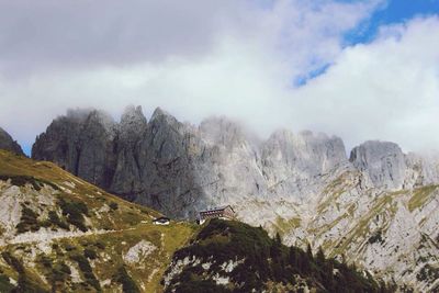 Scenic view of mountains against cloudy sky