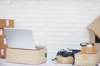 Close-up of camera and laptop on table