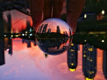 Close-up of crystal ball with reflection in city