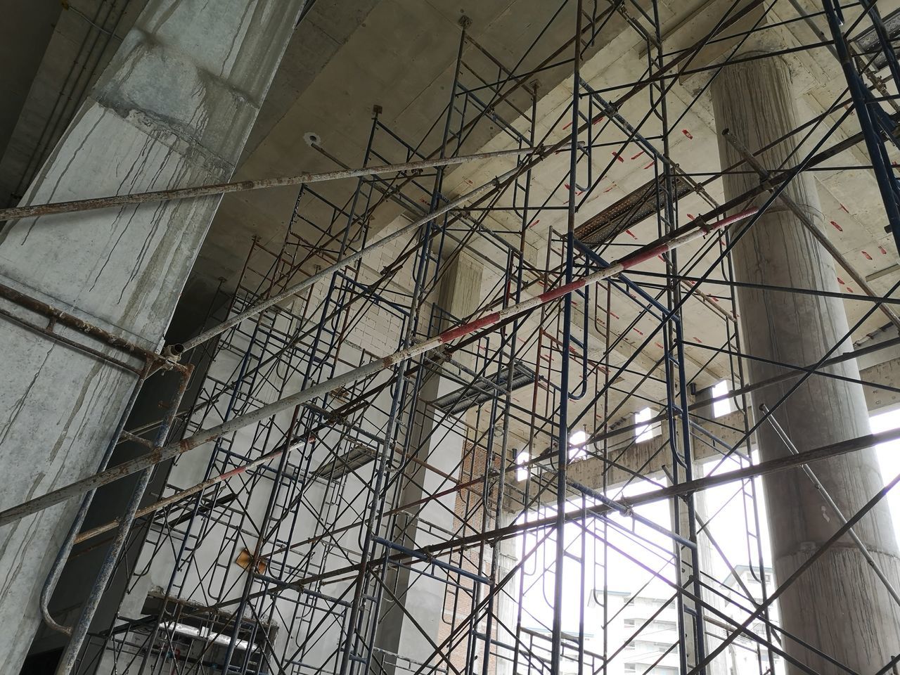 LOW ANGLE VIEW OF BUILDING SEEN THROUGH METAL WINDOW