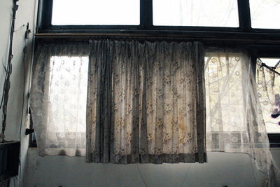 Low angle view of window in abandoned building