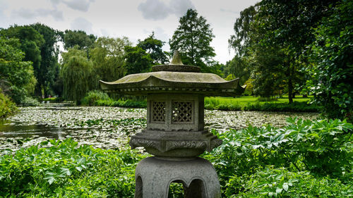 Gazebo in garden against trees in park