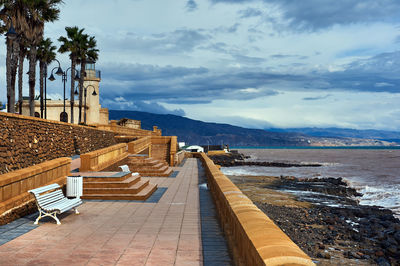 Empty promenade at roquetas de mar against sky