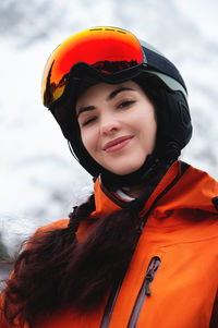 Young woman of caucasian ethnicity looks to the side and smiles, raising her head to the sky