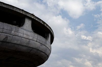 Low angle view of old abandoned building against sky