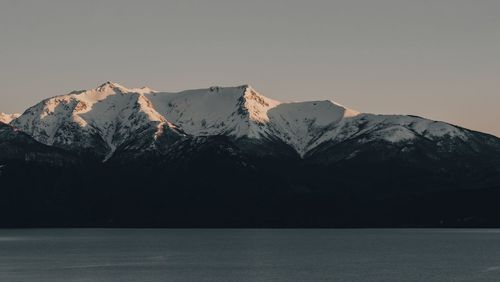 Scenic view of snowcapped mountains against clear sky