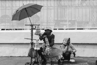 People sitting on umbrella