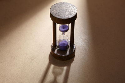 High angle view of hourglass on table