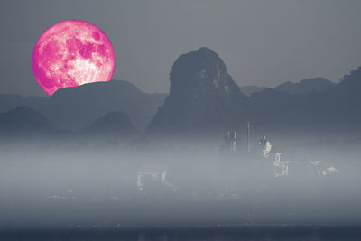 Scenic view of silhouette mountains against sky at night