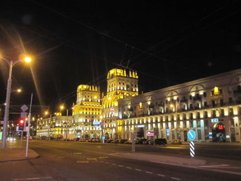 Illuminated city street and buildings at night