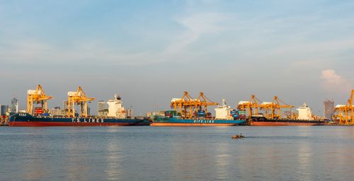 View of commercial dock by sea against sky