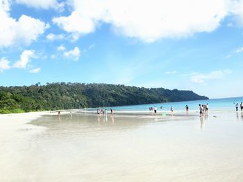 People on beach against sky