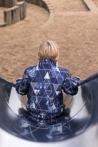 Rear view of boy on slide