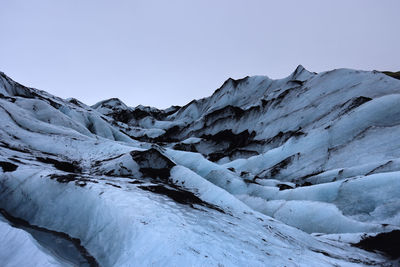 Scenic view of snowcapped mountains against clear sky