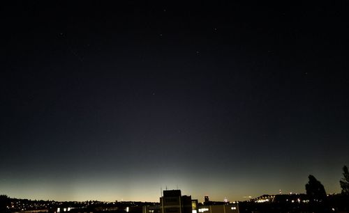 High section of buildings against sky at night