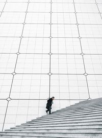 Full length of a man walking on staircase