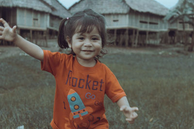 Portrait of cute boy standing on field