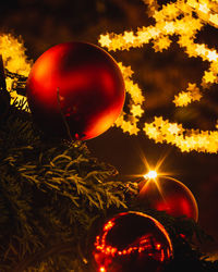 Close-up of christmas lights against sky at night