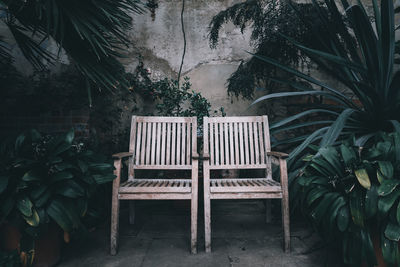 Rear view of woman sitting on chair against sky