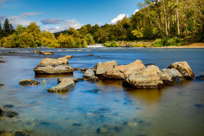 Scenic view of rocks in lake against sky