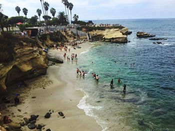 High angle view of people enjoying at beach