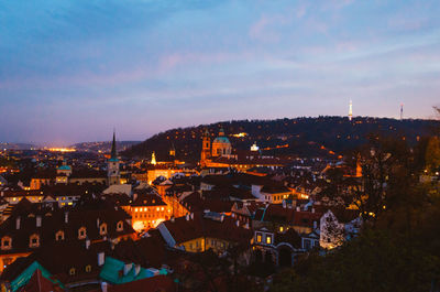 High angle shot of illuminated cityscape against sky at dusk