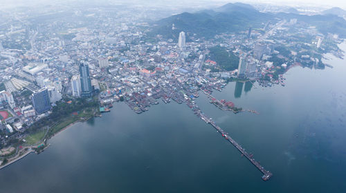 Aerial view of buildings by sea in city