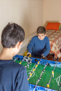 High angle view of boys playing table football