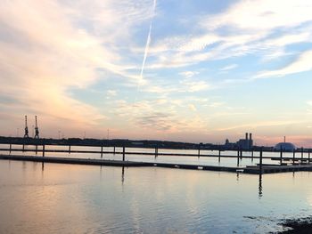 Bridge over sea against sky during sunset