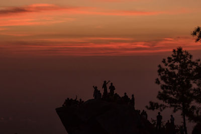 Silhouette statue against sky during sunset