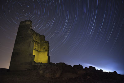 Starry sky achieved by a long exhibition and an old building in ruins