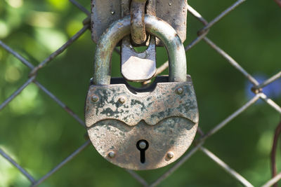 Close-up of padlock on rusty metal