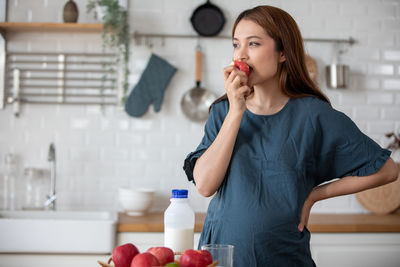 Young woman holding food at home