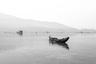 Boat in lake against sky