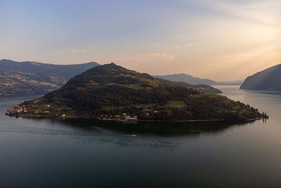 Scenic view of bay against sky at sunset